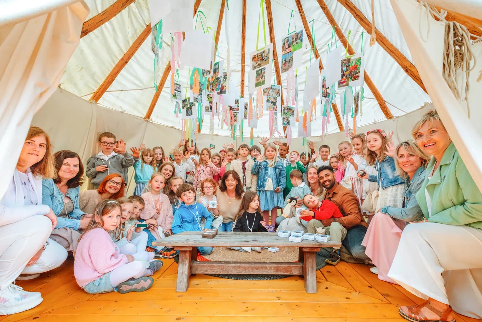 Děti a učitelky uvnitř tee-pee na školní zahradě